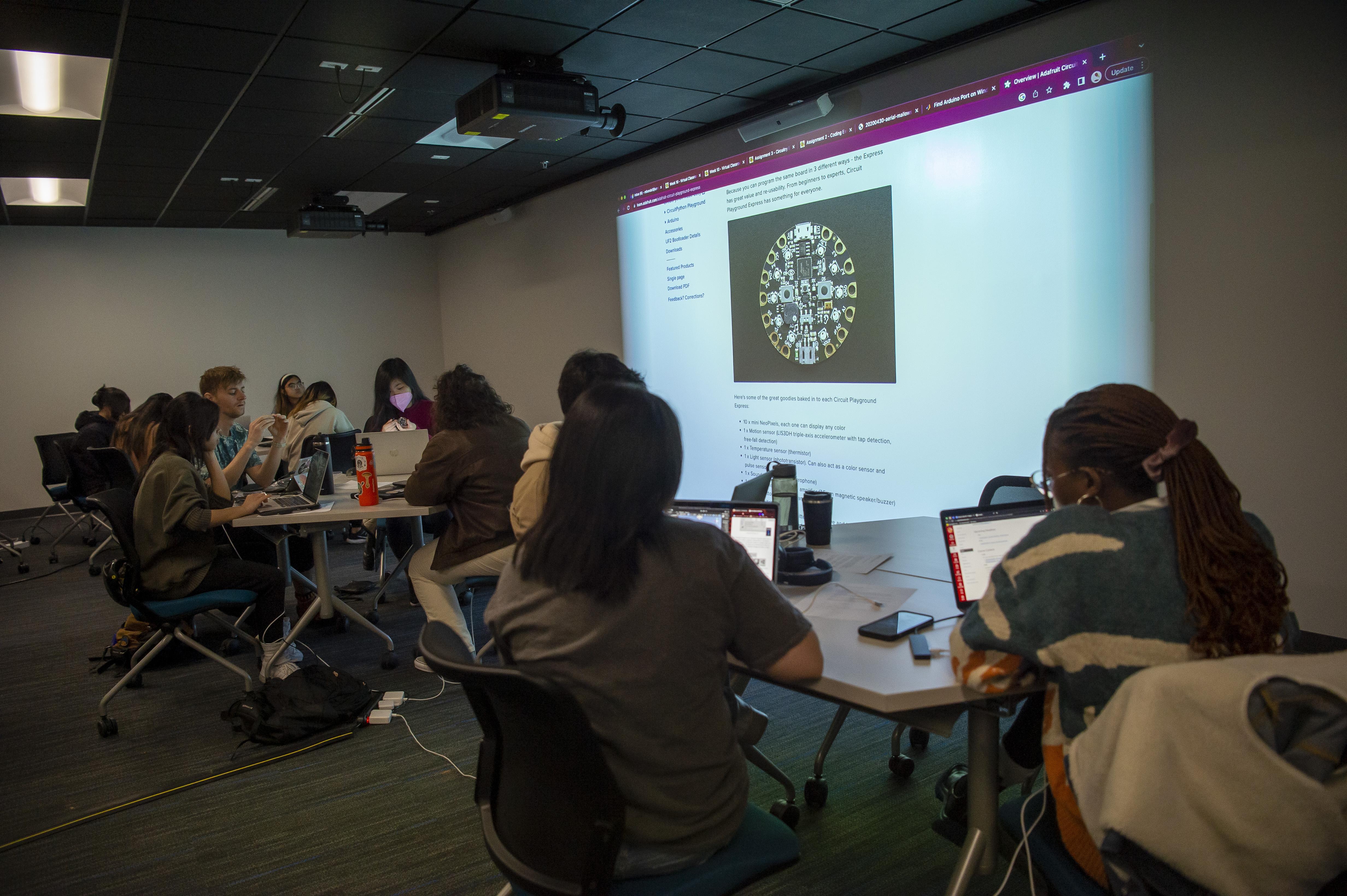 Students learning how to use an arduino circuit playground